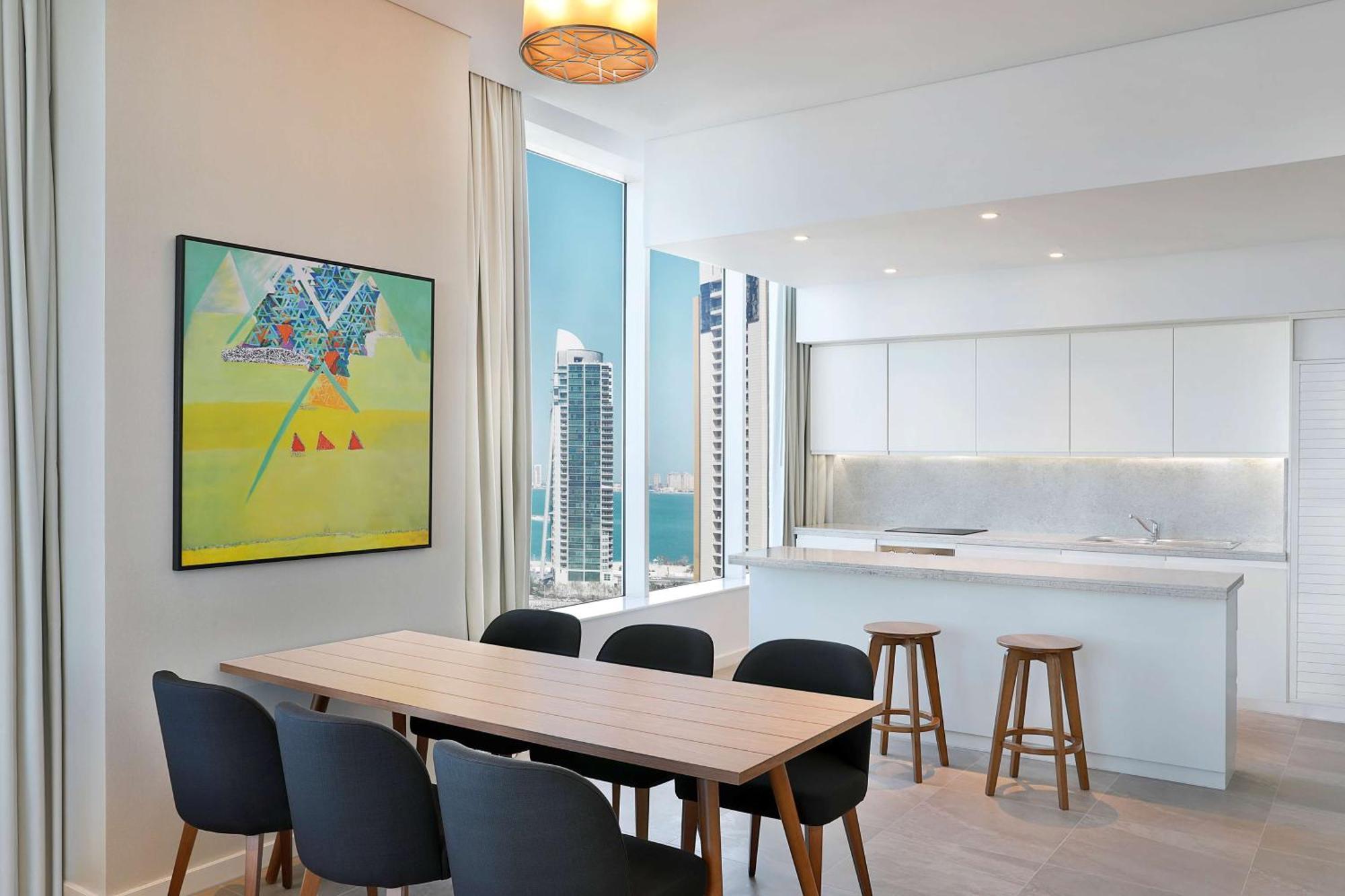 Aleph Doha Residences, Curio Collection By Hilton Εξωτερικό φωτογραφία The kitchen and dining area of a typical apartment